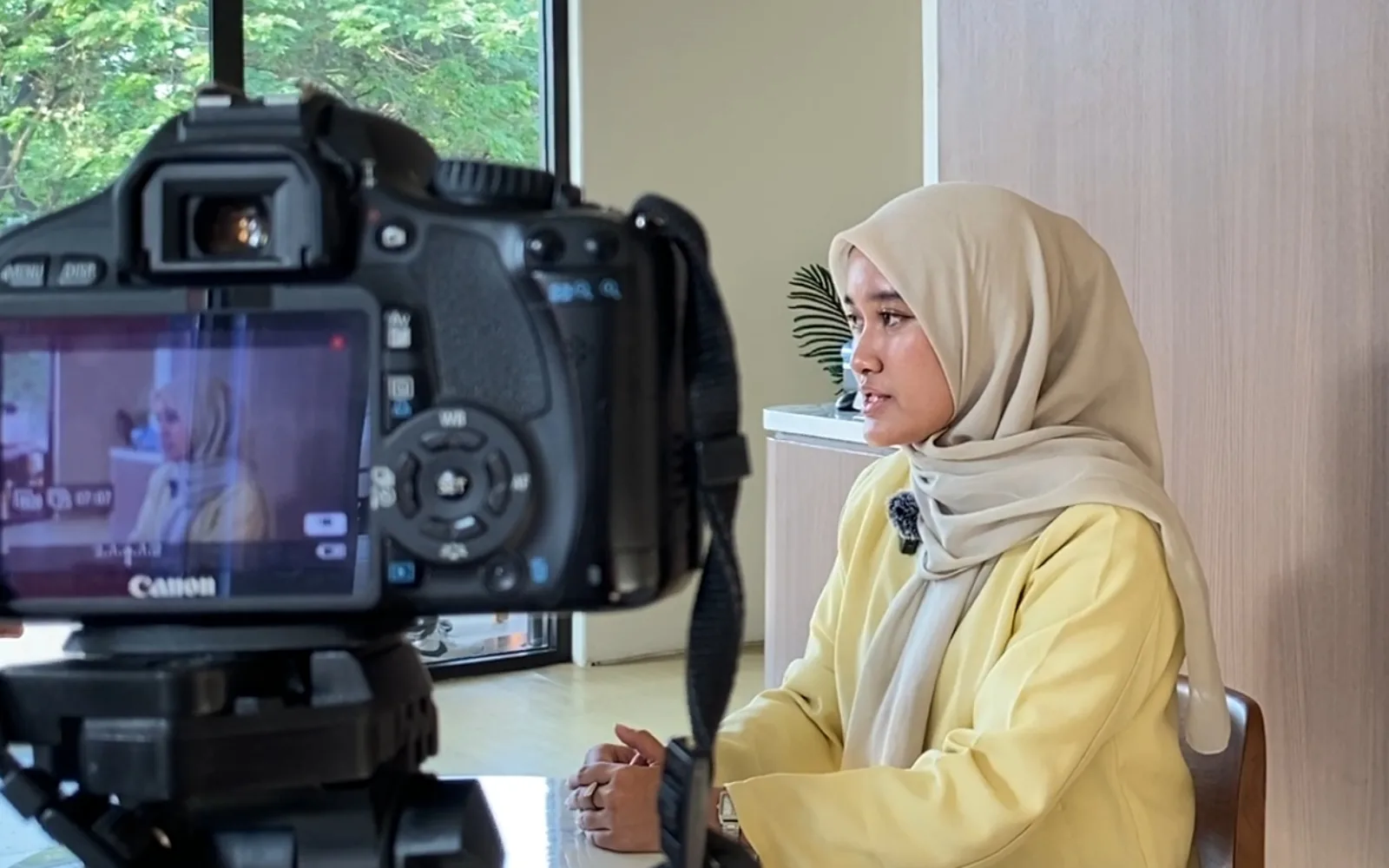 A CrescentVoices interview in progress, seen past the camera filming it