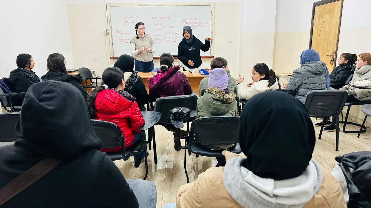 Atikah Syarah Ismail teaching a class of Palestinian children in Palestine.